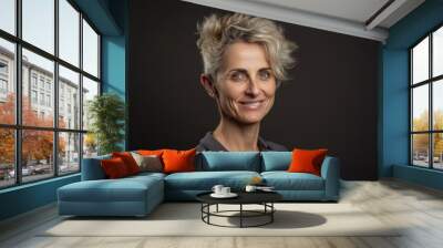 Portrait of a beautiful middle-aged business woman on a dark background Wall mural