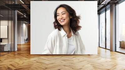 Portrait of a happy young asian woman smiling against white background Wall mural