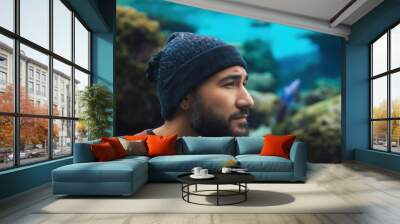 Portrait of a young man looking at the sea in the aquarium Wall mural