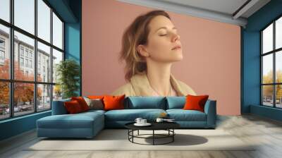 portrait of a young woman with closed eyes on a pink background Wall mural