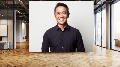 Portrait photography of a happy Indonesian man in his 40s wearing a chic cardigan against a white background  Wall mural