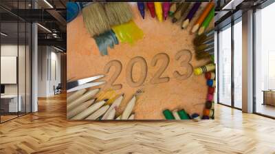 Overhead shot of school supplies with the number 2023. Brushes, pencils, artistic tools. Art And Craft Work Tools. Wall mural