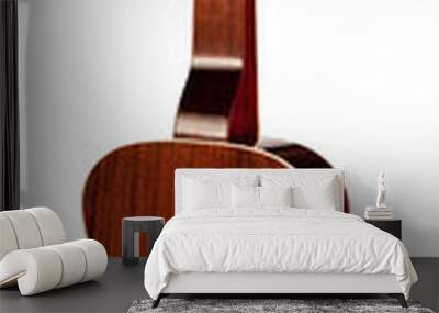 A closeup of the back of an acoustic guitar, showcasing its rich mahogany wood grain, chrome tuning pegs, and a subtle cream binding. Wall mural