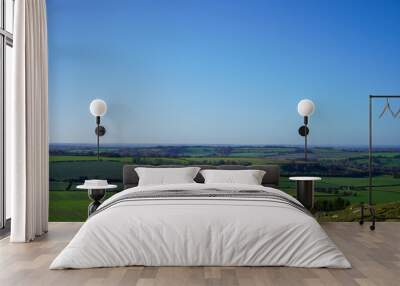 View over green countryside and blue skys Wall mural