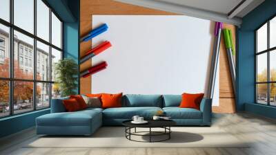 Color markers and white sheet of paper on bright modern wooden desk Wall mural