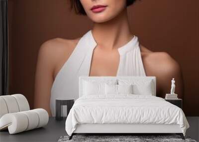 studio portrait of a brunette female model with short hair wearing a low cut white dress on brown background, fashion photography Wall mural