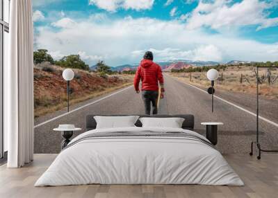 Man walking on road in Utah Wall mural