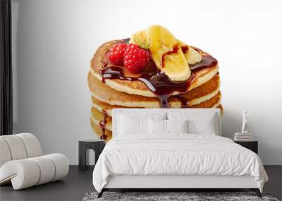 Stack of pancakes with banana,raspberries and chocolate syrup on white Wall mural