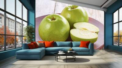 Two green apples with slice on rustic ceramic plate Wall mural