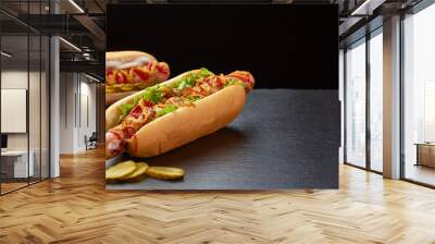 Two juicy hot dogs on dark slate background Wall mural