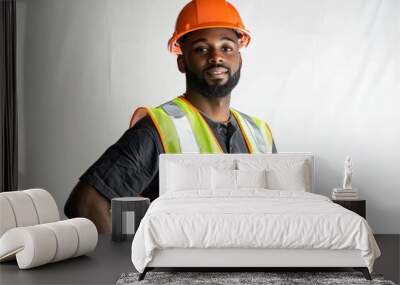 A confident male construction worker wearing an orange hard hat and a reflective safety vest, posing with hands on hips against a plain background. Wall mural