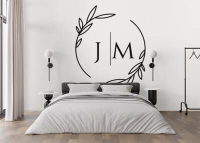 Letter JM wedding monogram logo design with simple natural circle leaf frame Wall mural