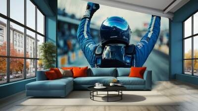 A racer in a blue racing outfit celebrates winning at the racetrack Wall mural