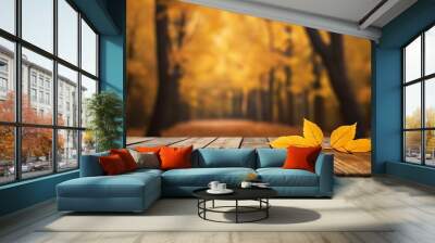 Autumn fall background with a wooden table top and blurred forest with leaves falling Wall mural