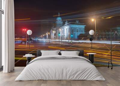 Blurred motion long exposure lines light of car headlamps headlights at night. Street view of city center of Dublin with The Custom House in background in Dublin, Ireland. Wall mural