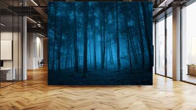 dark blue colored spooky forest tree landscape. blue color filter effect used. Wall mural