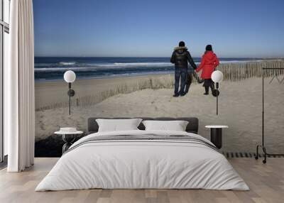 couple watches the ocean in winter Wall mural