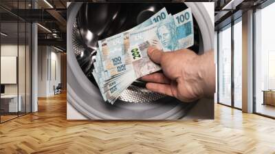 Brazilian money in the washing machine, Concept, Money laundering, Illegal business, Black market Reais, criminal activity Wall mural