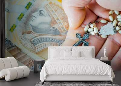 Christian rosary hand-held with money. Concept of church business and corolla. Polish two hundred zlotys Wall mural