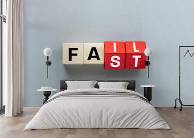 FAIL and FAST concept. letters on wooden blocks changing the word fast to fail, concept, beautiful gray background. flat lay, copy space Wall mural