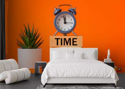 Time to sell symbol. alarm clock and time to sell, word concept on wooden blocks. Beautiful orange background, succulent on desk, business and sales concept. Copy space Wall mural