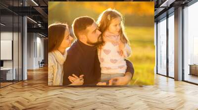 .Family playing in autumn park having fun Wall mural