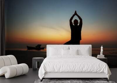 guy at sunset on the island practices yoga, silhouette Wall mural