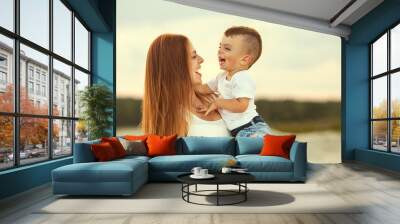 happy mother and son in the mountains playing Wall mural