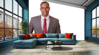 A black businessman poses for a portrait on a white background. An African American executive in a suit and tie stands looking at the camera on a blank backdrop Wall mural