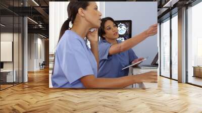 african american and hispanic doctors working together on computers and phone Wall mural