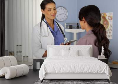 African American gynecologist talking to patient with tablet Wall mural