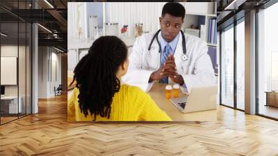 african american patient talking to african american doctor at office desk Wall mural