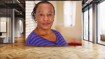 an elderly african american woman poses for a portrait in her house Wall mural