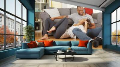 Black couple sitting on floor talking Wall mural