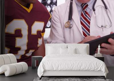 Close-up of medical doctor looking at tablet computer with sport Wall mural