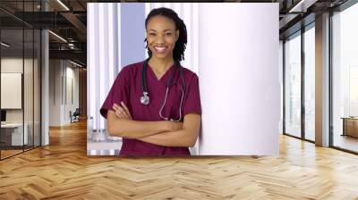 Confident black woman doctor smiling in office Wall mural