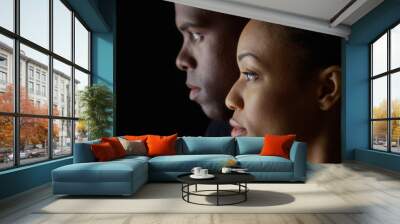 Dramatic side view of two young African American people on black background Wall mural