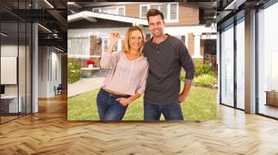 Excited first time homebuyers standing in front of their new home Wall mural