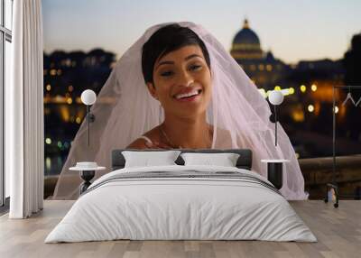 Happy beautiful bride in Rome Italy lifts away her veil laughing and excited Wall mural