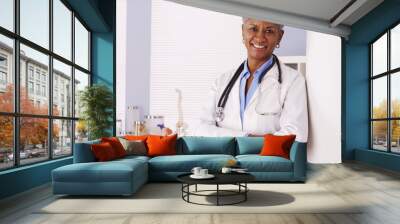 Happy Black Senior doctor standing in office  Wall mural