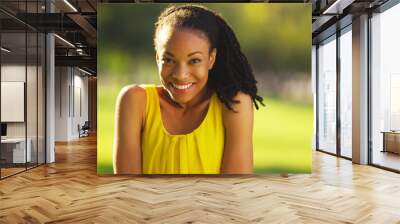 happy black woman smiling in a park Wall mural