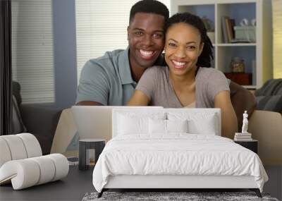 Happy young black couple with laptop and bills Wall mural