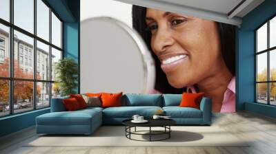 Portrait of African American woman smiling at a mirror Wall mural