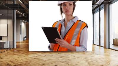 Woman wearing orange vest and hardhat working on tablet on white background Wall mural