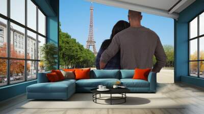 Youthful black couple in love enjoy view of Eiffel Tower together Wall mural