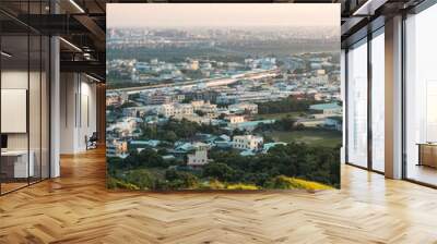 View of city from the beautiful mountain. Blue sky and green meadow. Wall mural