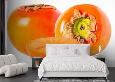 Two whole and half persimmon isolated on white background Wall mural