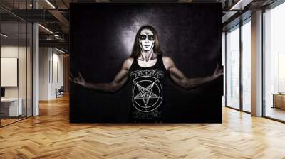 Long haired man in goth style clothes with Satan symbols. Wall mural