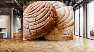 typical mexican bread - chocolate concha on top of two vanilla conchas side view Wall mural