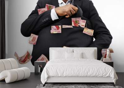 Black Businessman holding black bag full of Bermudan dollar notes isolated on white background, money falling from bag Wall mural